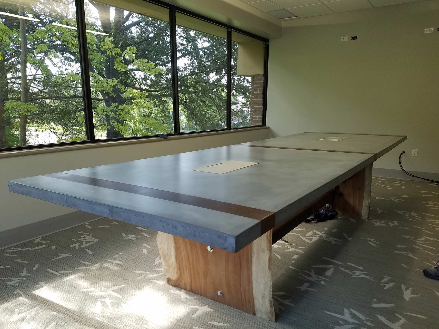 Concrete conference table top on natural wood base