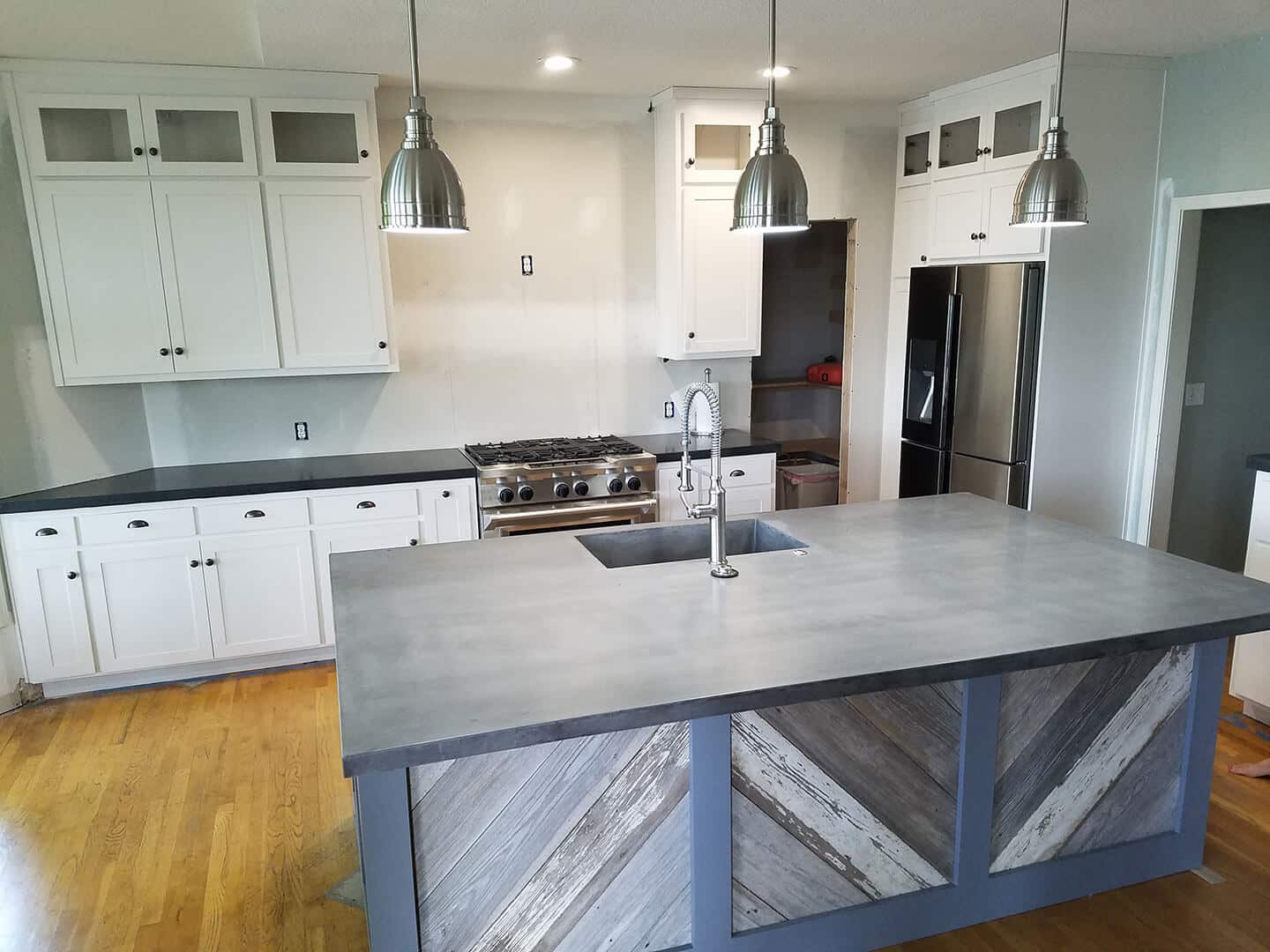 Farmhouse kitchen with large overcast color top on kitchen island