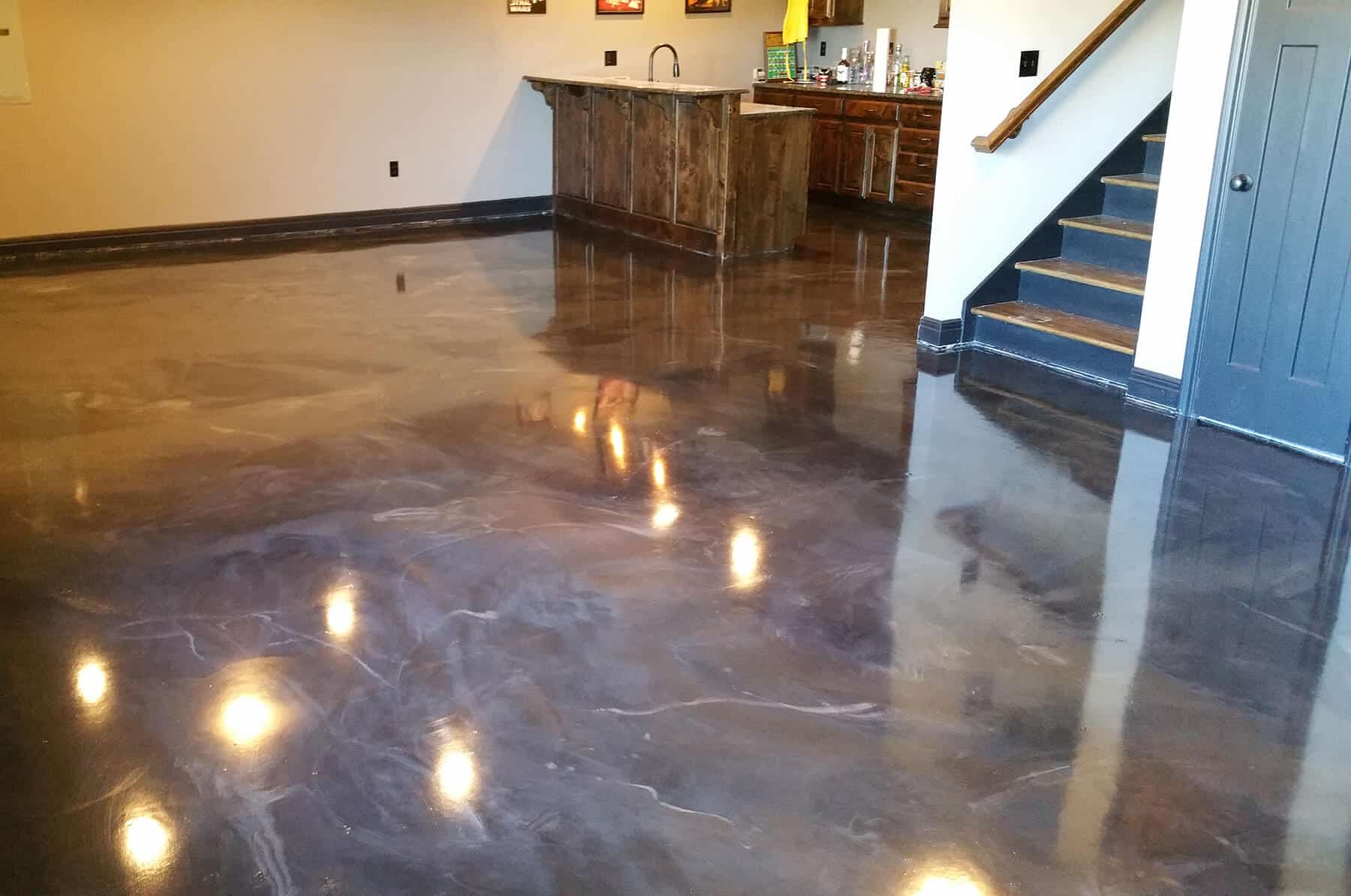 concrete flooring at bottom of stairs