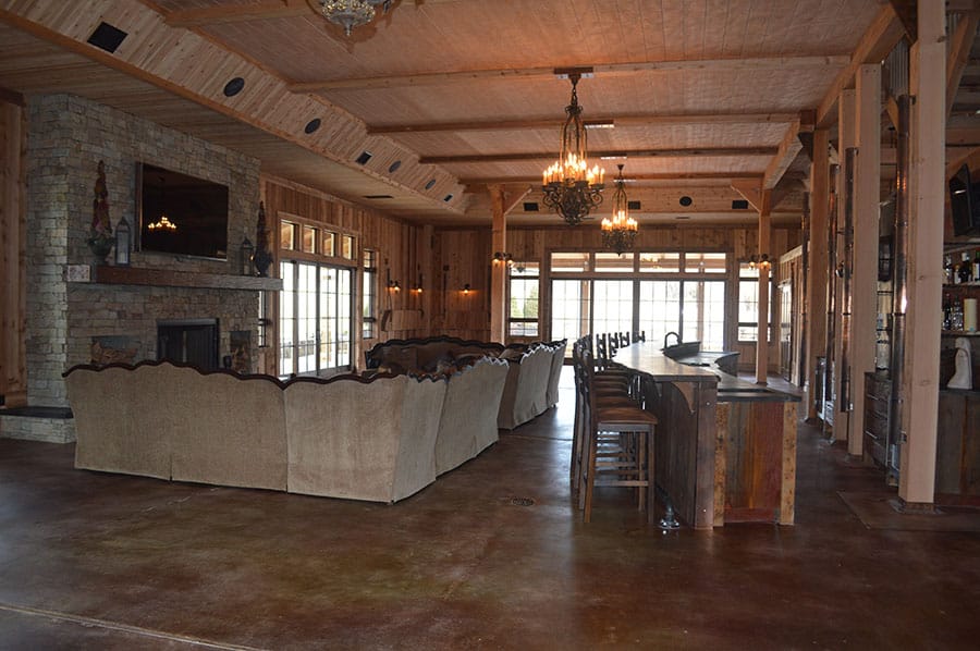 Large lodge with concrete flooring and two level concrete bar