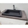 concrete vessel sink installed in decorative cabinet