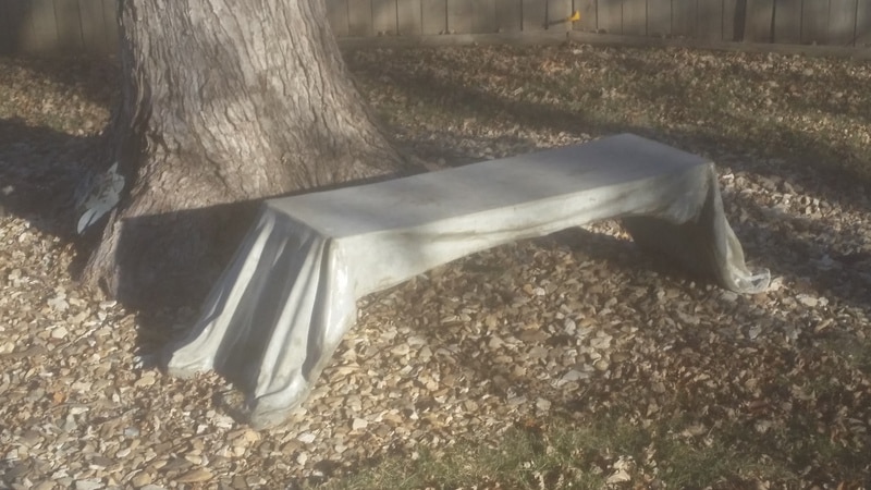 decorative gray concrete bench with the appearance of draped cloth