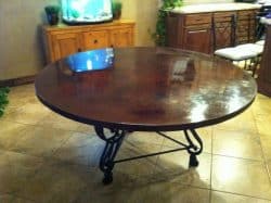 Dark brown concrete table on decorative iron base