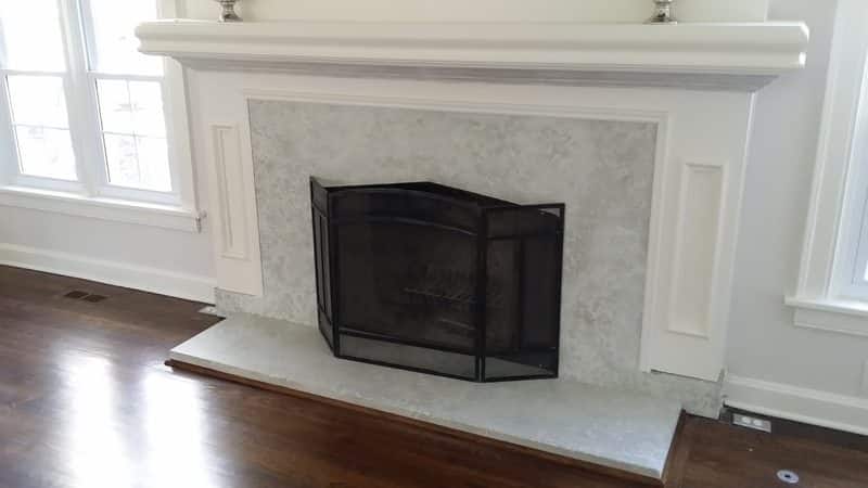 white and gray marble appearance fireplace surround made of concrete