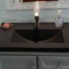 black concrete sink with small basin