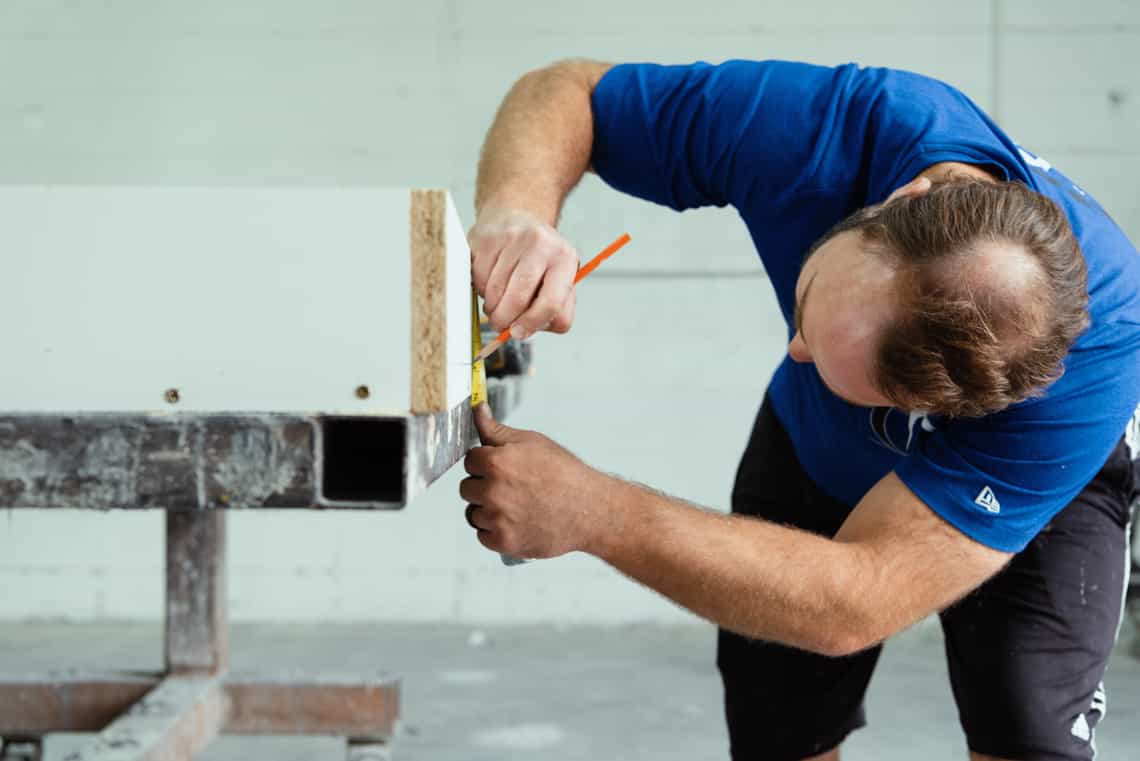 Man measuring a mold for a concrete table