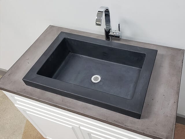 black vessel sink in concrete bathroom counter